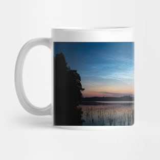 Night shining clouds over lake Mug